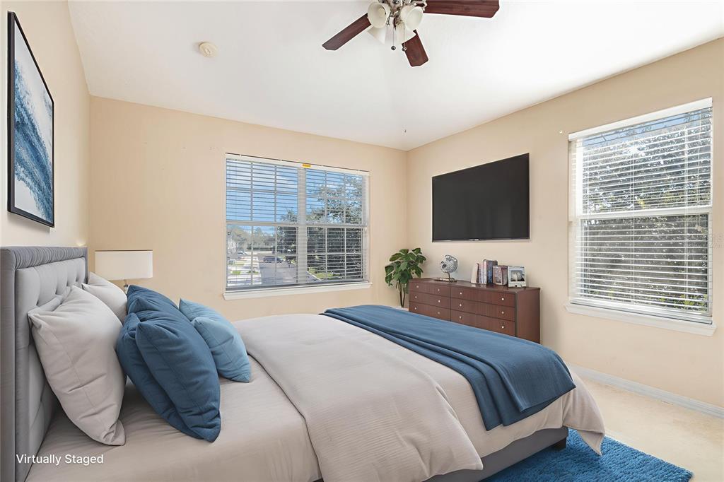 6686 South Goldenrod Road, Unit 139A Orlando, FL 32822 - Photo 16 of 23 a bedroom with a bed and a flat screen tv