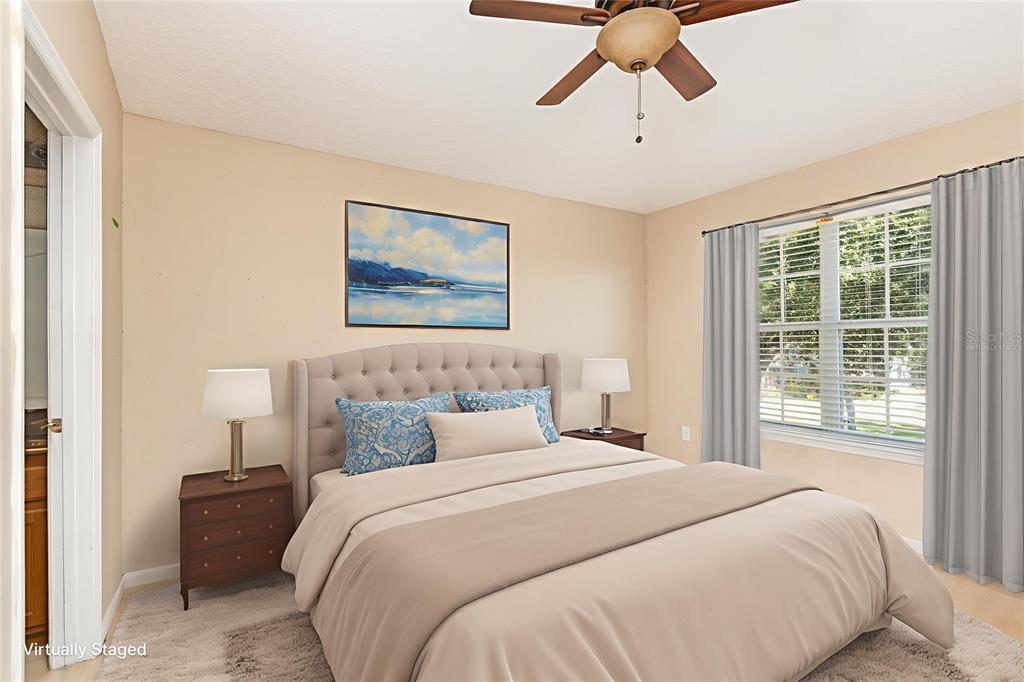6686 South Goldenrod Road, Unit 139A Orlando, FL 32822 - Photo 18 of 23 a bedroom with a large bed and a chandelier