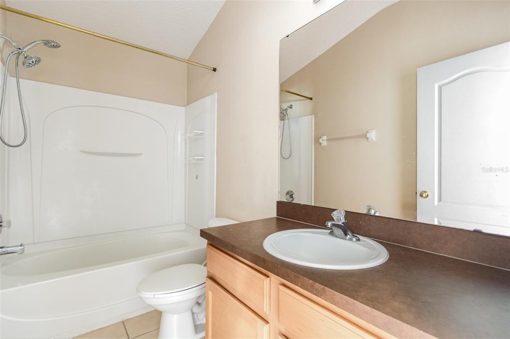 6686 South Goldenrod Road, Unit 139A Orlando, FL 32822 - Photo 20 of 23 a bathroom with a sink toilet and shower