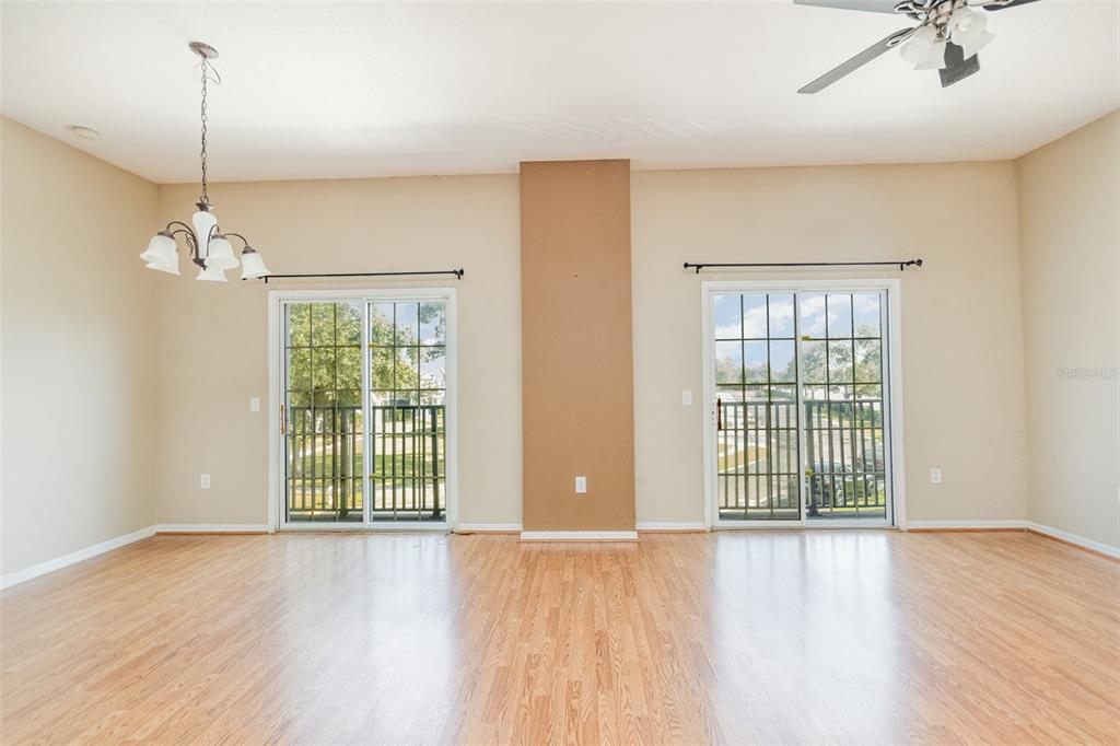 6686 South Goldenrod Road, Unit 139A Orlando, FL 32822 - Photo 6 of 23 a view of an empty room with a window and wooden floor