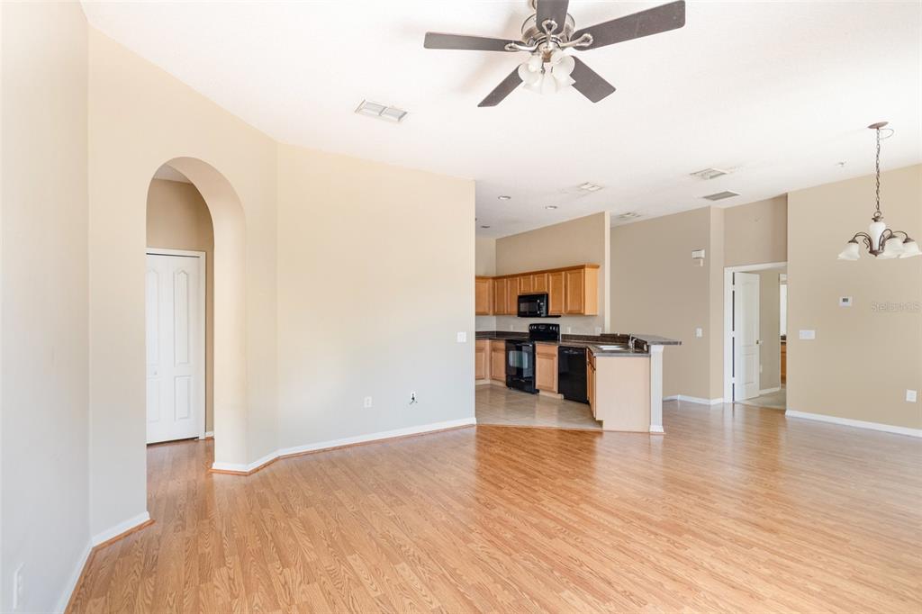 6686 South Goldenrod Road, Unit 139A Orlando, FL 32822 - Photo 9 of 23 a view of a kitchen with kitchen island wooden floor and stainless steel appliances