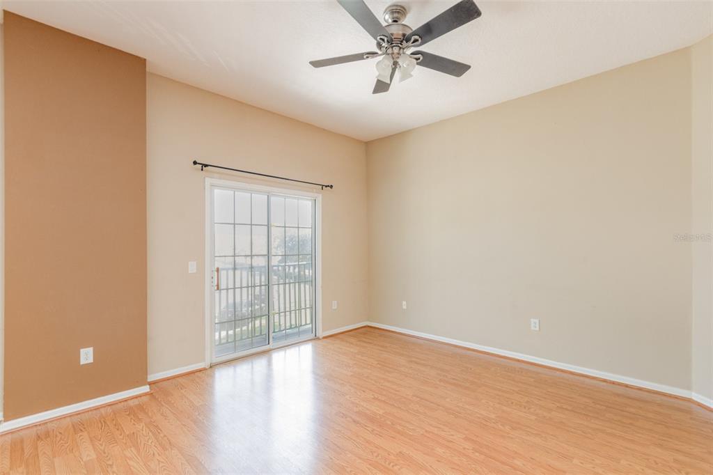 6686 South Goldenrod Road, Unit 139A Orlando, FL 32822 - Photo 10 of 23 wooden floor in an empty room with a window