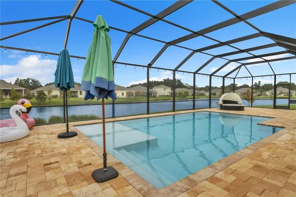 a view of a swimming pool with a lounge chair