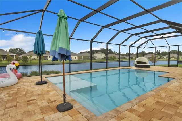 a view of a swimming pool with a lounge chair