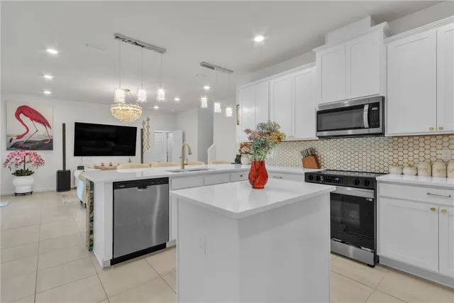 a kitchen with stainless steel appliances a stove microwave and cabinets