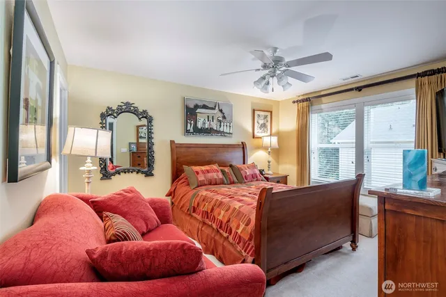 a bedroom with a bed couch and window
