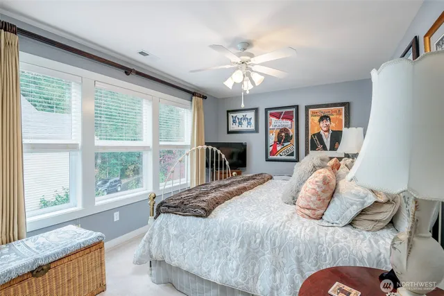 a bedroom with a large bed and a large window