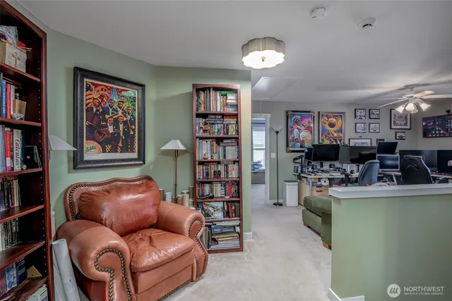 a living room with furniture and a bookshelf