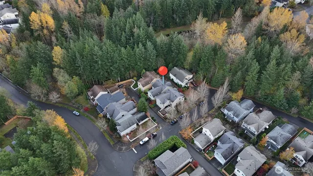an aerial view of multiple houses with yard