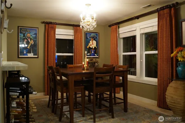 a view of a dining room with furniture and chandelier