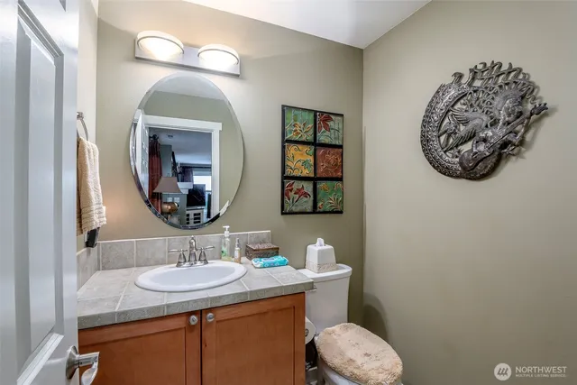 a bathroom with a toilet sink and mirror