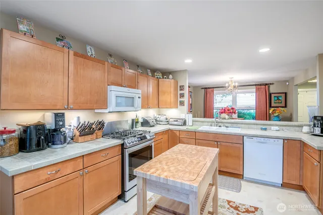 a kitchen with stainless steel appliances granite countertop sink stove and cabinets