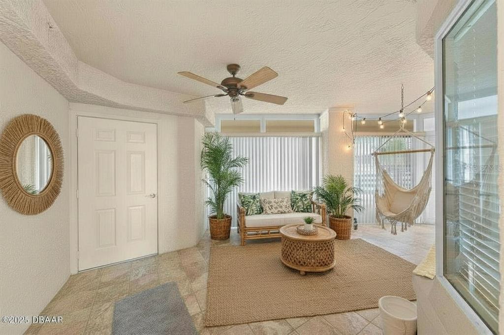 4575 South Atlantic Avenue, Unit 6209 Ponce Inlet, FL 32127 - Photo 5 of 31 a living room with furniture and a potted plant