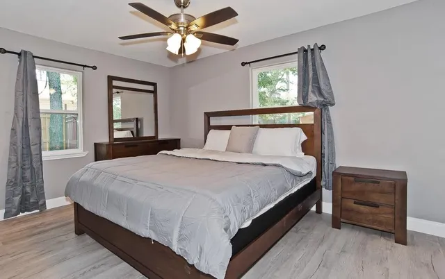 a large bed sitting in a bedroom next to a window