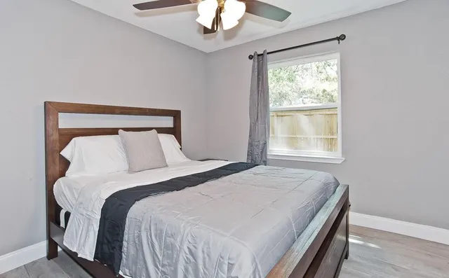 a bedroom with a bed and a chandelier