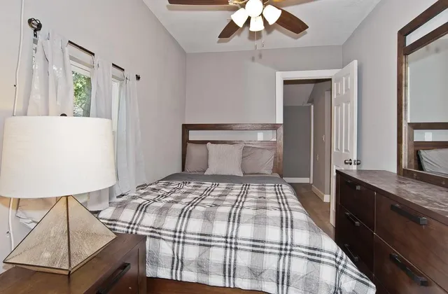 a bedroom with a bed and a chandelier