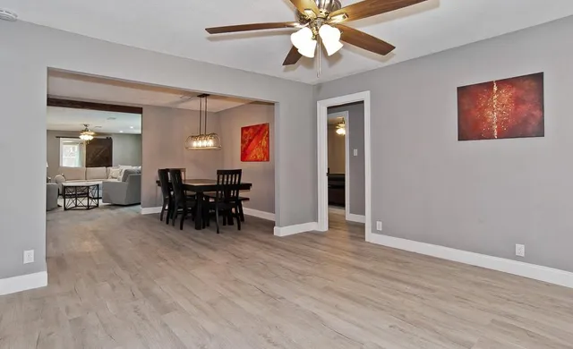 a view of a livingroom with furniture and chandelier fan