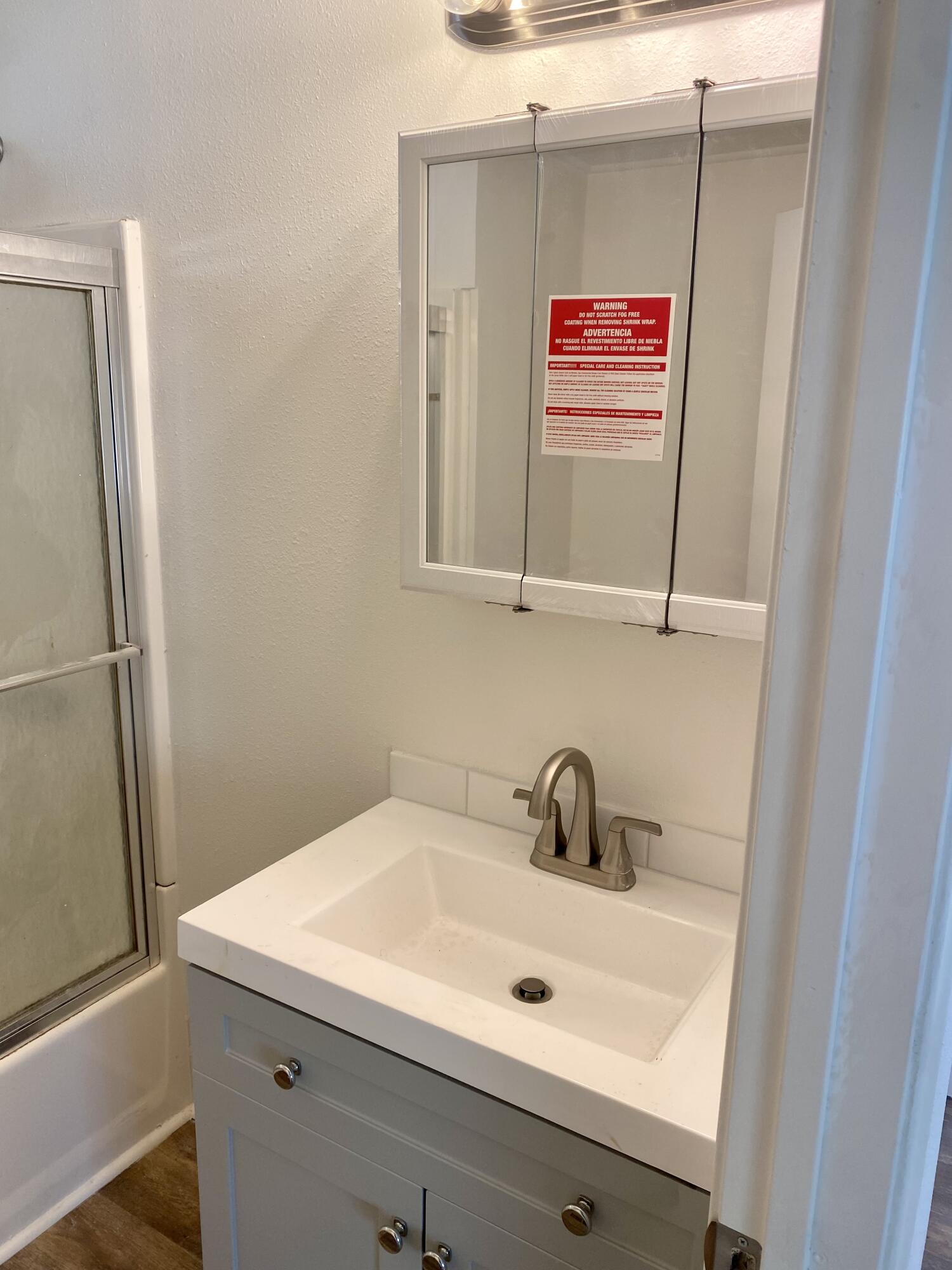 6480 Katherine Road, Unit 6 Simi Valley, CA 93063 - Photo 12 of 13 a bathroom with a sink and a mirror