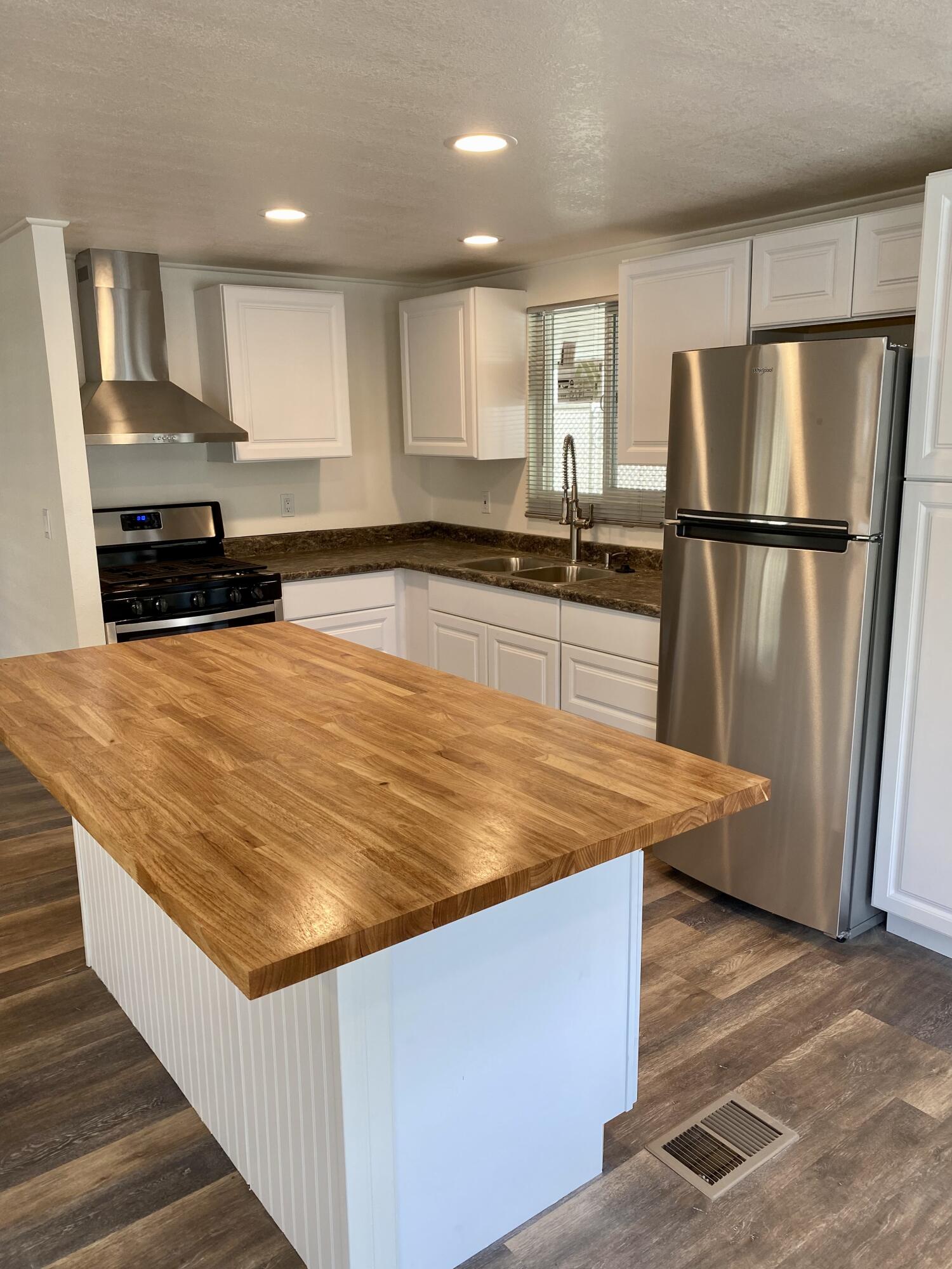 6480 Katherine Road, Unit 6 Simi Valley, CA 93063 - Photo 2 of 13 a kitchen with stainless steel appliances granite countertop a refrigerator a sink and a stove