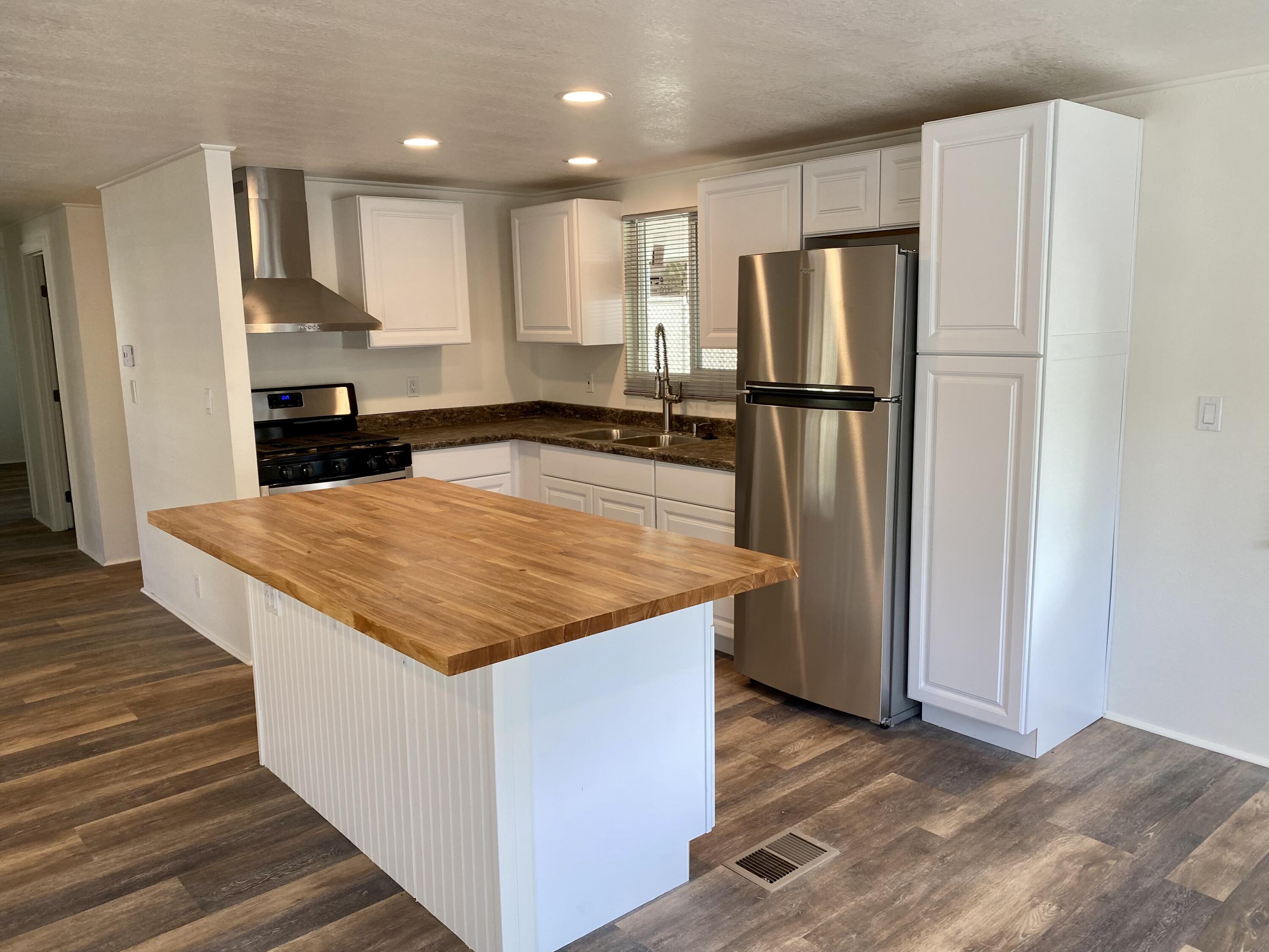 6480 Katherine Road, Unit 6 Simi Valley, CA 93063 - Photo 3 of 13 a kitchen with stainless steel appliances granite countertop a refrigerator and a stove