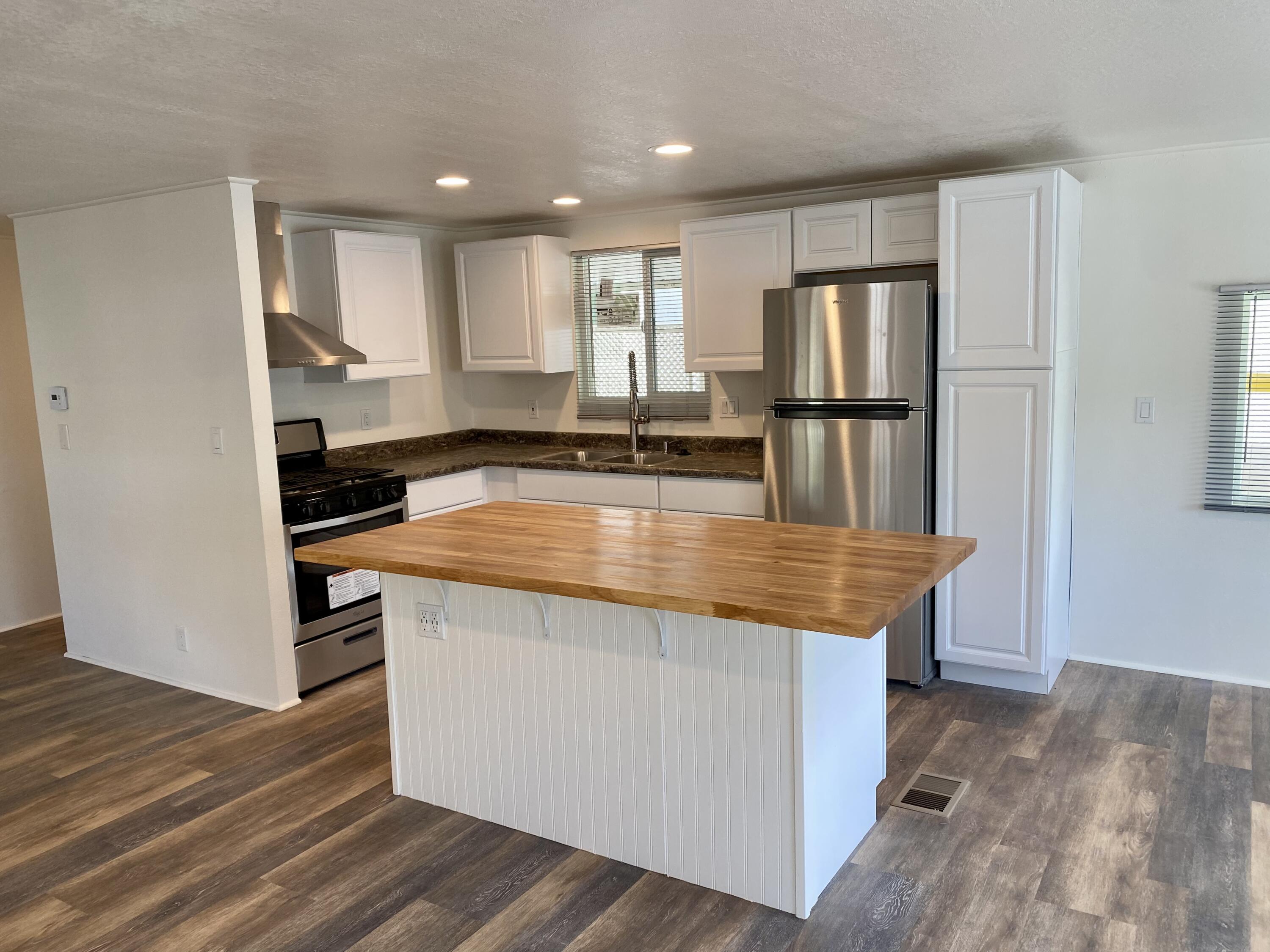 6480 Katherine Road, Unit 6 Simi Valley, CA 93063 - Photo 4 of 13 a kitchen with stainless steel appliances granite countertop a stove refrigerator and cabinets