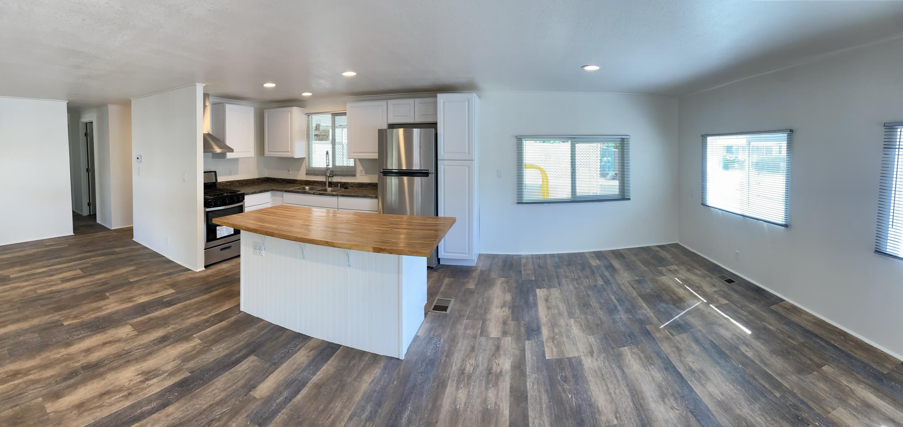 6480 Katherine Road, Unit 6 Simi Valley, CA 93063 - Photo 6 of 13 a kitchen with wooden floors and center island