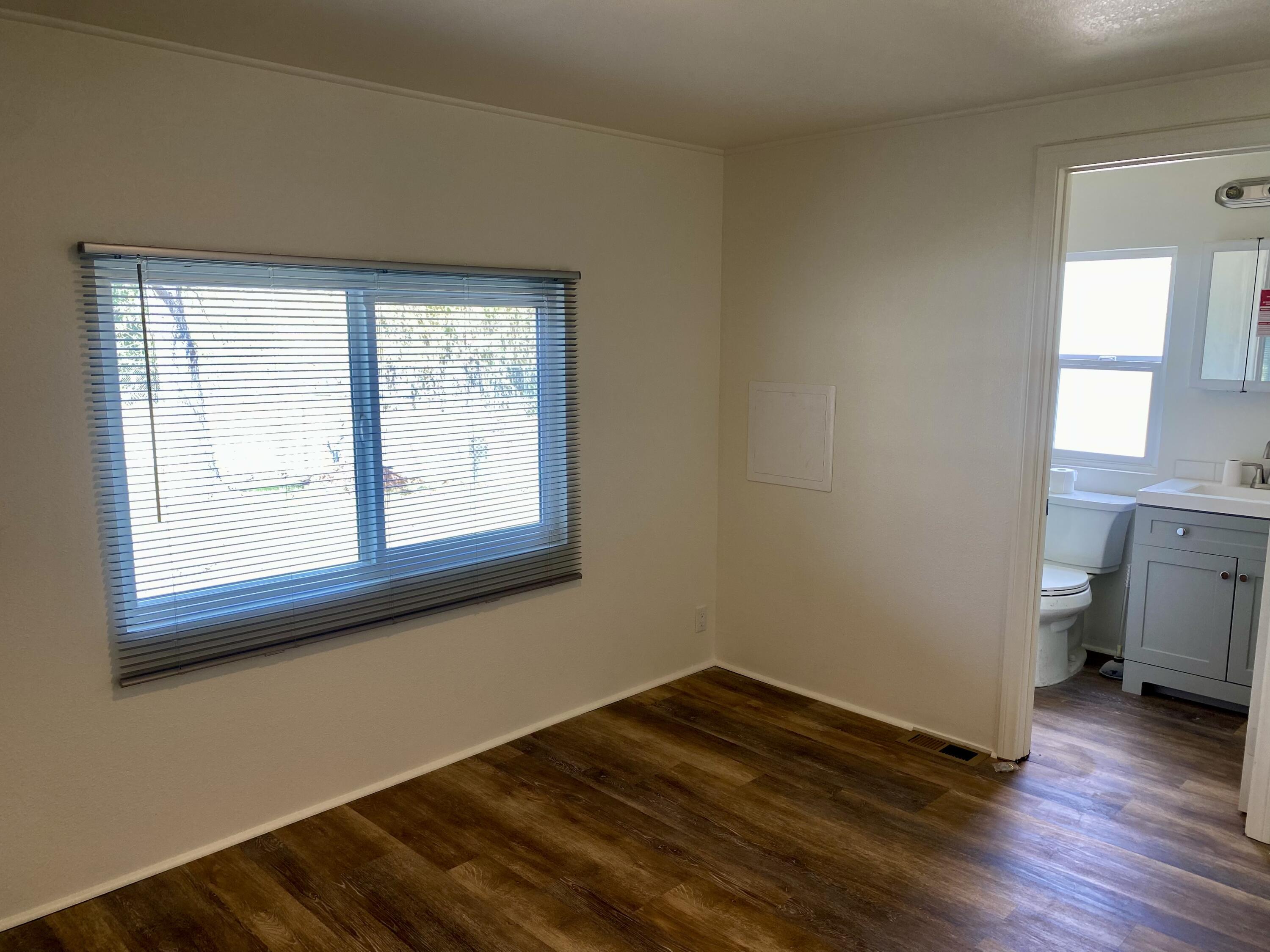 6480 Katherine Road, Unit 6 Simi Valley, CA 93063 - Photo 10 of 13 a view of a room with wooden floor and a window