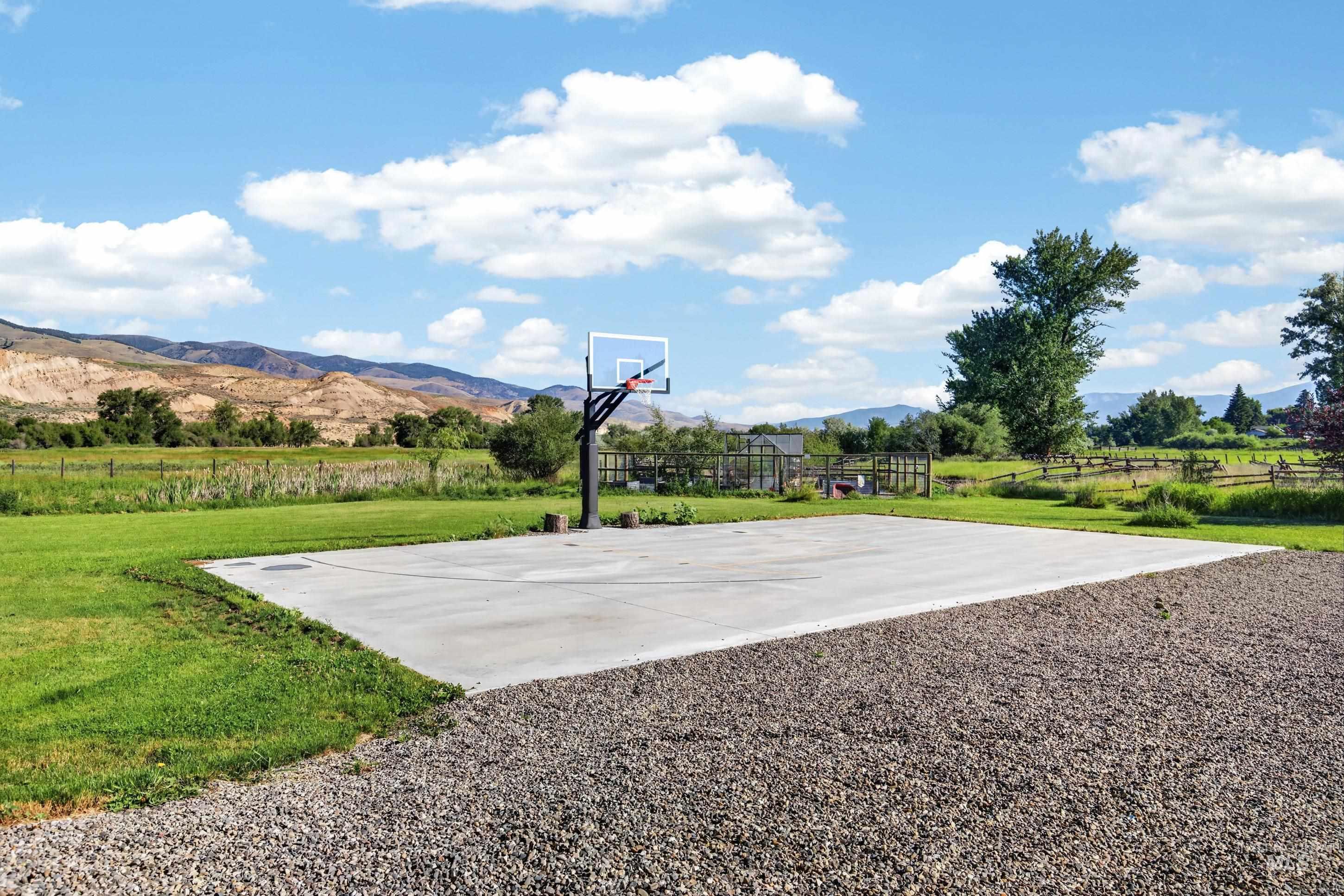 63 Mountain View Road Salmon, ID 83467 - Photo 47 of 50 Concrete sports court featuring an adjustable basketball hoop