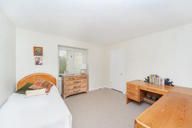 a view of a room with lots of chairs and wooden floor
