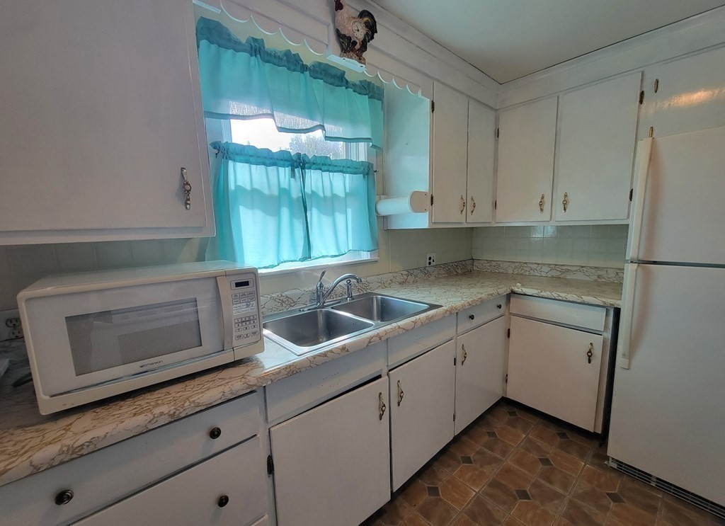 52 Ella Street Athol, MA 01331 - Photo 12 of 23 a kitchen with a sink and cabinets