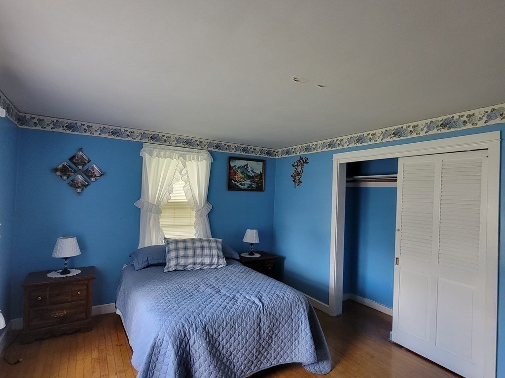 52 Ella Street Athol, MA 01331 - Photo 17 of 23 a bedroom with a bed and wooden floor