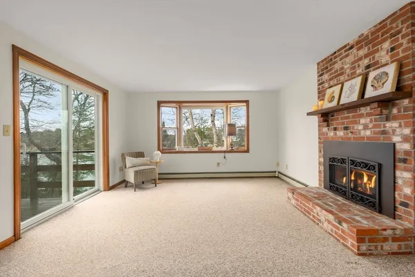 a view of an empty room with furniture and a fireplace
