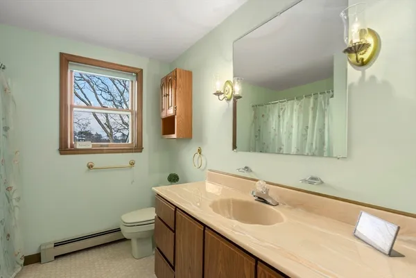 a bathroom with a toilet sink and mirror