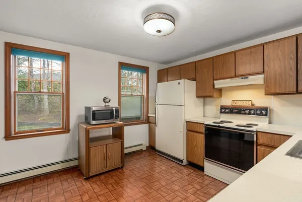 a kitchen with a refrigerator stove and sink