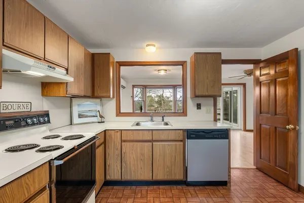 a kitchen with a sink stove and refrigerator