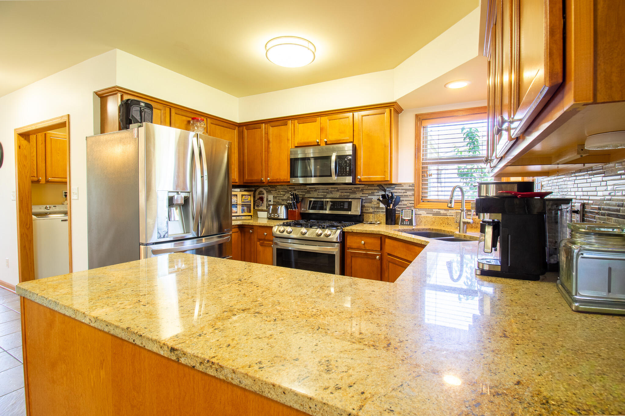 2550 Honelee Court Valparaiso, IN 46385 - Photo 13 of 37 a kitchen with stainless steel appliances granite countertop a stove top oven a sink and a refrigerator