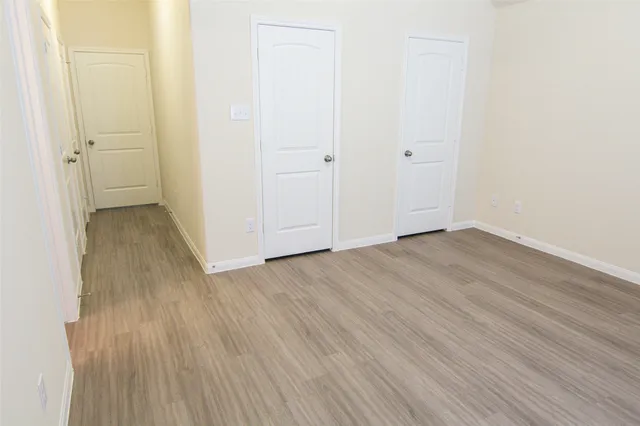 an empty room with wooden floor