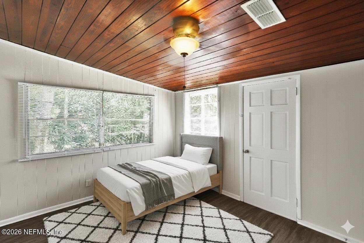 5456 Timuquana Road Jacksonville, FL 32210 - Photo 7 of 27 a bedroom with a bed and a window