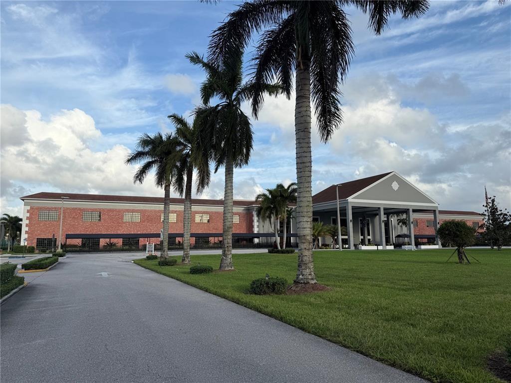 138 Fanshaw D, Unit D Boca Raton, FL 33434 - Photo 13 of 22 front view of a house with a yard