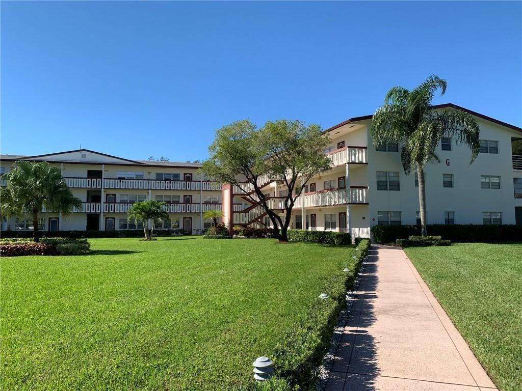 138 Fanshaw D, Unit D Boca Raton, FL 33434 - Photo 17 of 22 a front view of house with yard