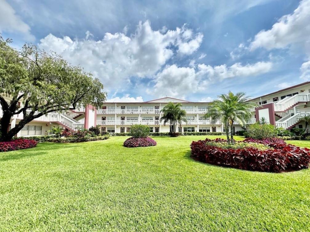 138 Fanshaw D, Unit D Boca Raton, FL 33434 - Photo 18 of 22 a view of outdoor space with garden and entertaining space