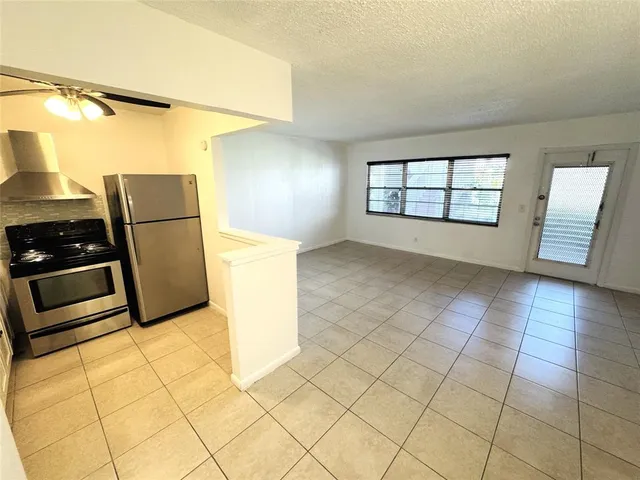a view of a kitchen with a sink and a stove top oven