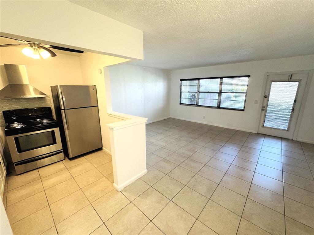 138 Fanshaw D, Unit D Boca Raton, FL 33434 - Photo 3 of 22 a view of a kitchen with a sink and a stove top oven