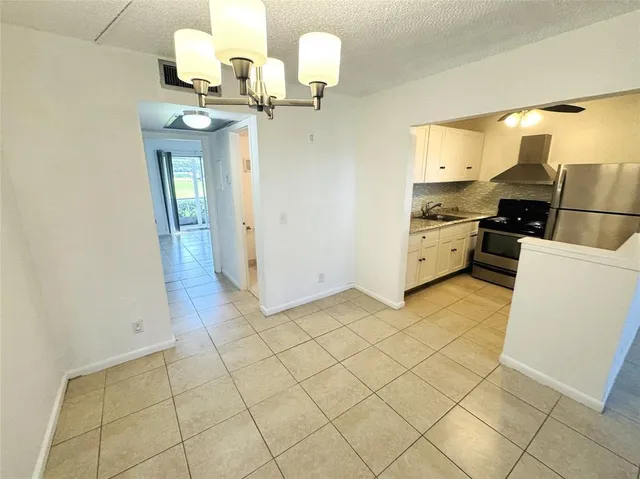 a kitchen with a sink cabinets and appliances
