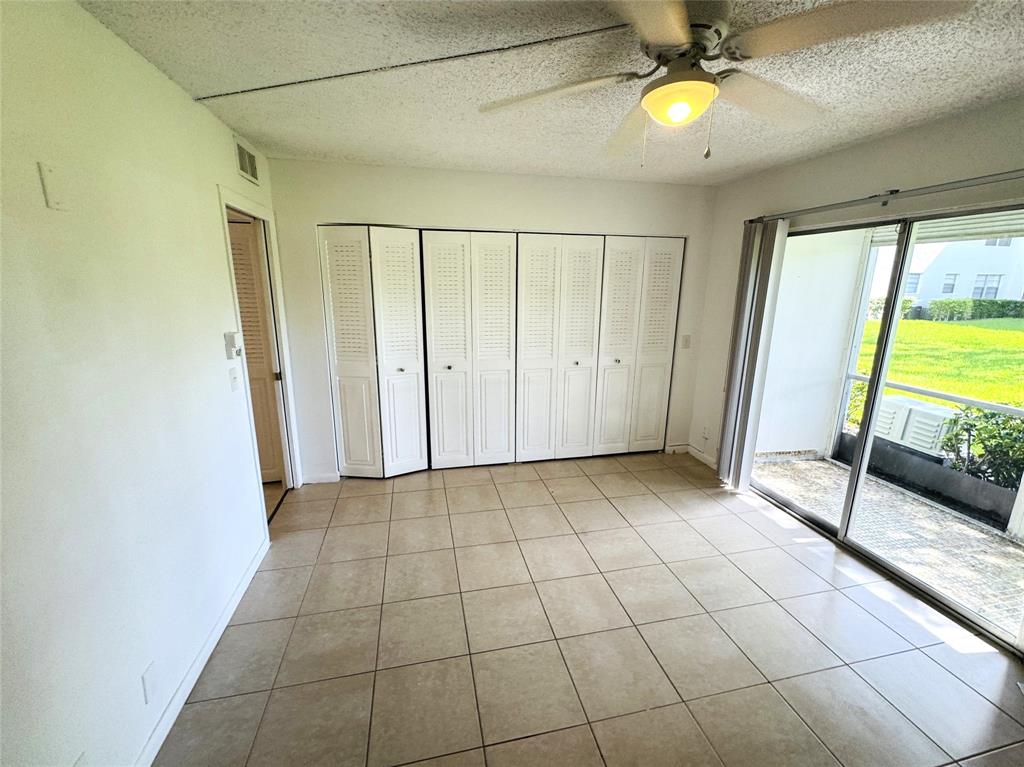 138 Fanshaw D, Unit D Boca Raton, FL 33434 - Photo 7 of 22 a view of an empty room with a window