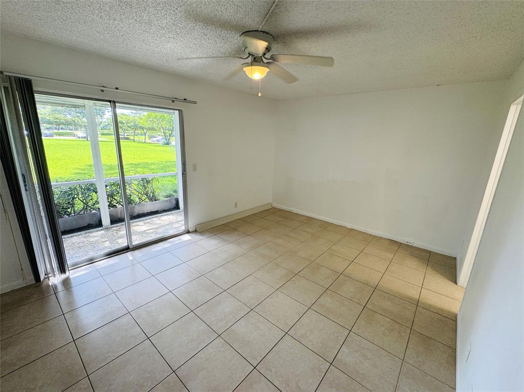 138 Fanshaw D, Unit D Boca Raton, FL 33434 - Photo 8 of 22 a view of an empty room and window