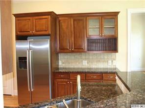 155 Sink Farm Road Mooresville, NC 28115 - Photo 6 of 16 a kitchen with granite countertop a refrigerator and cabinets