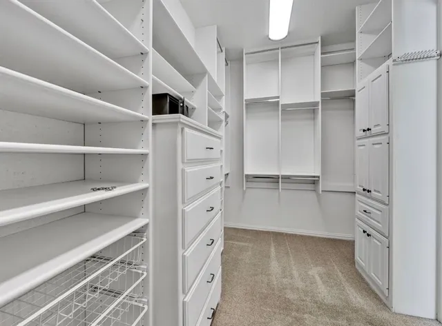 a view of walk in closet with empty racks