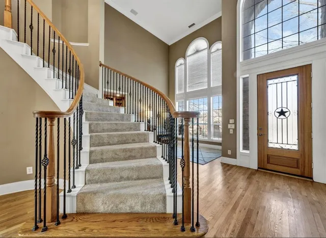a view of staircase with white walls and windows