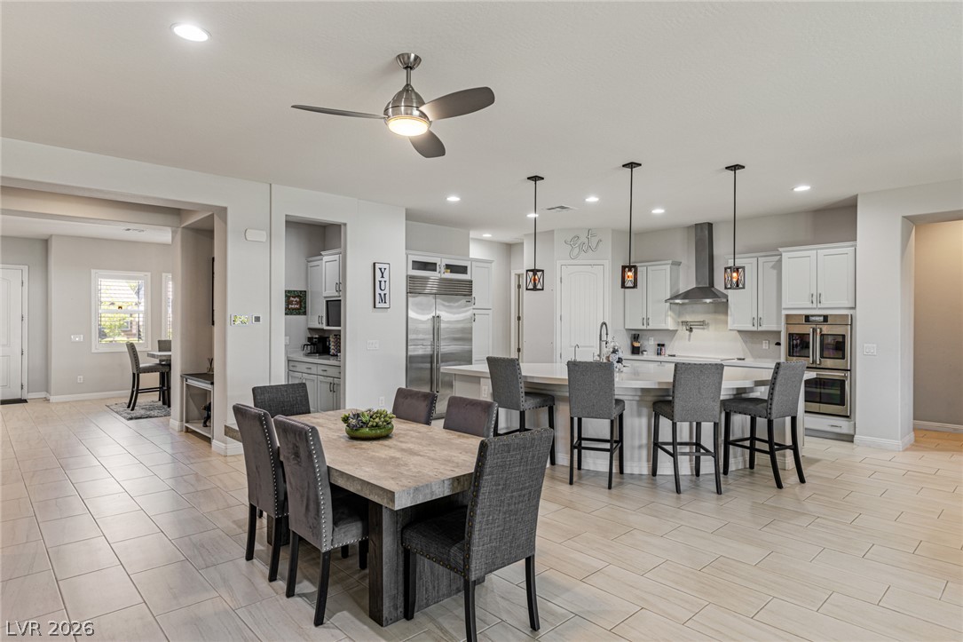 7036 Arabian Ridge Street Las Vegas, NV 89131 - Photo 22 of 64 An open-concept living space integrates a spacious dining area with a gourmet kitchen for effortless entertaining.